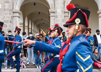 people in red and blue uniform standing on gray concrete floor