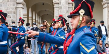 people in red and blue uniform standing on gray concrete floor
