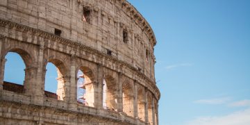 photo of coliseum under blue sky